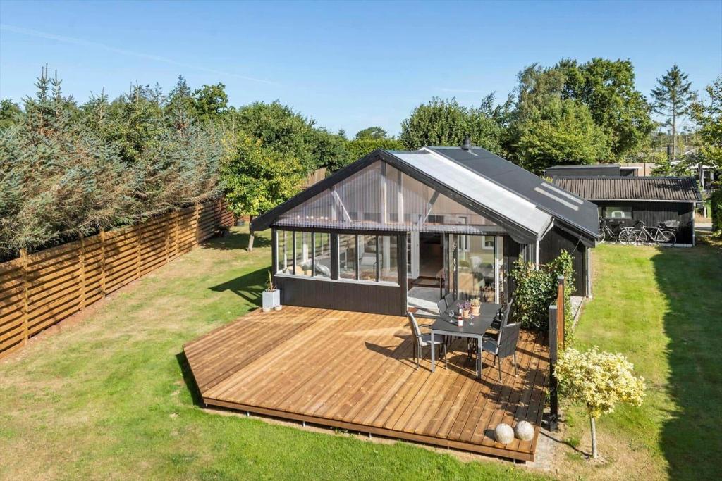 a house with a deck in a yard at OH514-Hadsund-Ryttermarken-37 in Hadsund