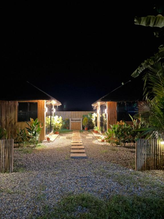 a night view of a house with lights at The Bamboo villas 2 in Pooc
