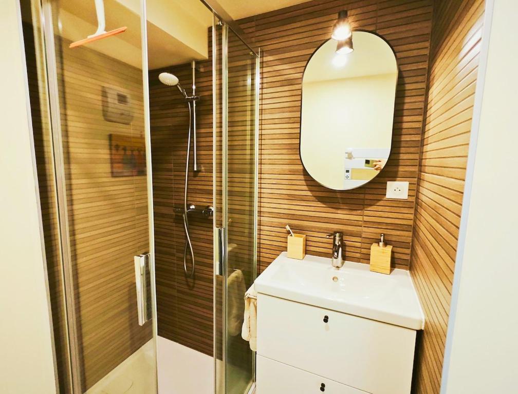 a bathroom with a shower and a sink and a mirror at Apt in hyper center of Lannion, next to City Hall in Lannion
