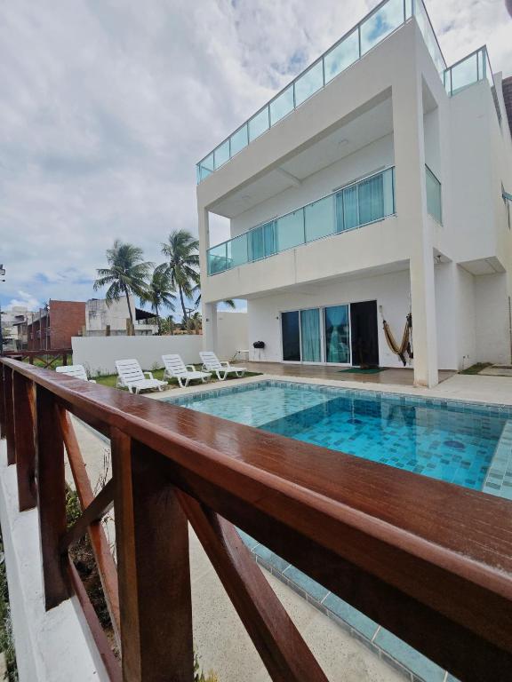a house with a swimming pool in front of it at Casa Beira Mar com Piscina Maragogi - Amar & Mar in Maragogi