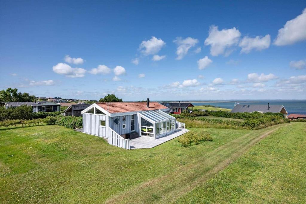 a house on a field with a view of the ocean at G608-Lemvig-Gyvelvej-8 in Lemvig