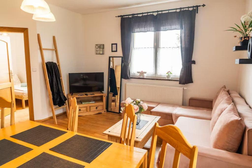 a living room with a couch and a table at Entire condominium, Boží Dar, Czech Republic in Boží Dar