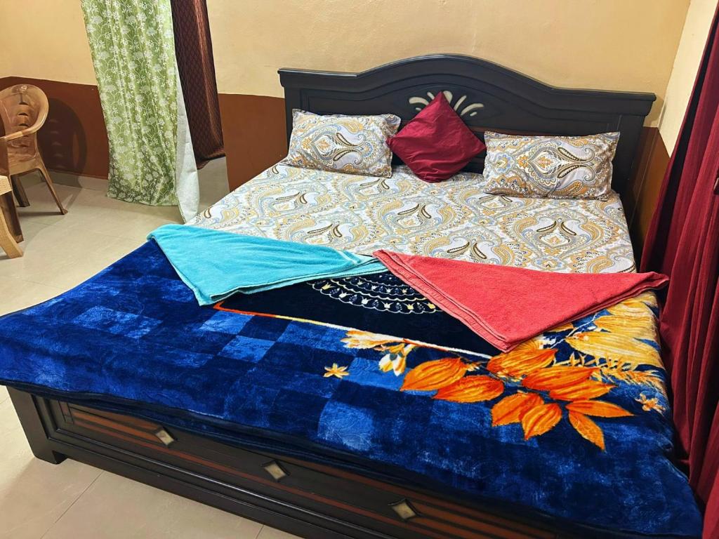 New HampiにあるNew Siddharth homestay hampiのベッド(カラフルなシーツ、枕付)