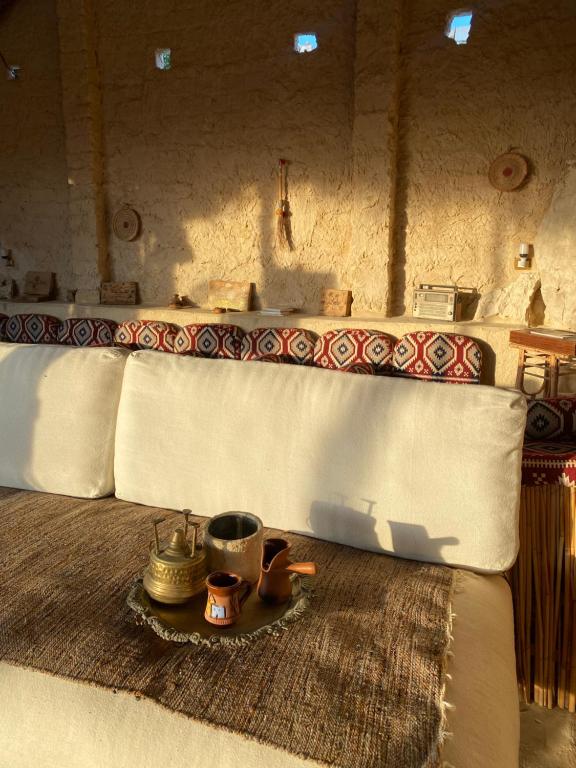 a room with a bed with a table and a counter at Soléi Salt in siwa oasis