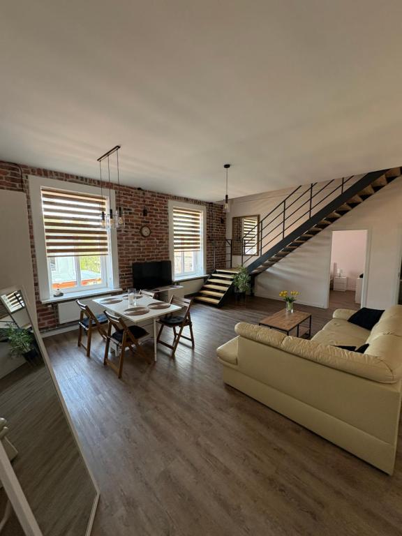 a living room with a couch and a table at Dream Apartment in Liepāja