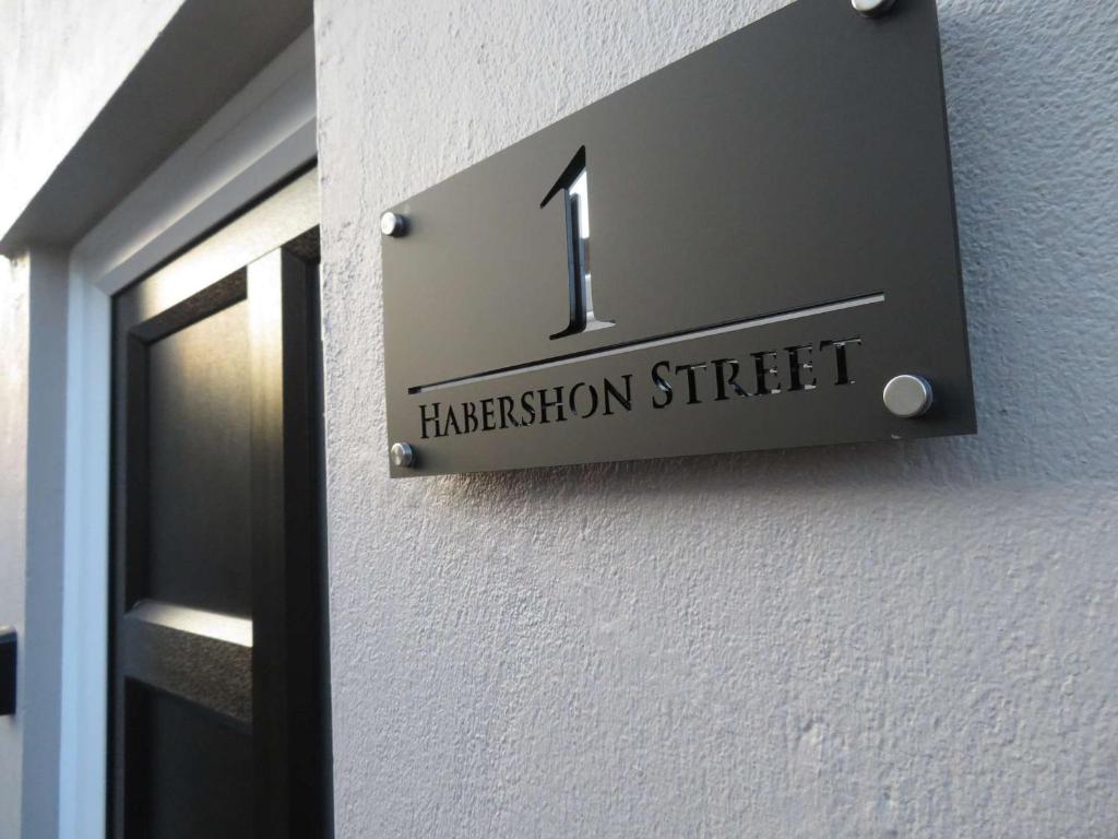 a sign on a building with the number one on it at La Casa de Class - Luxury & Comfort in Cardiff