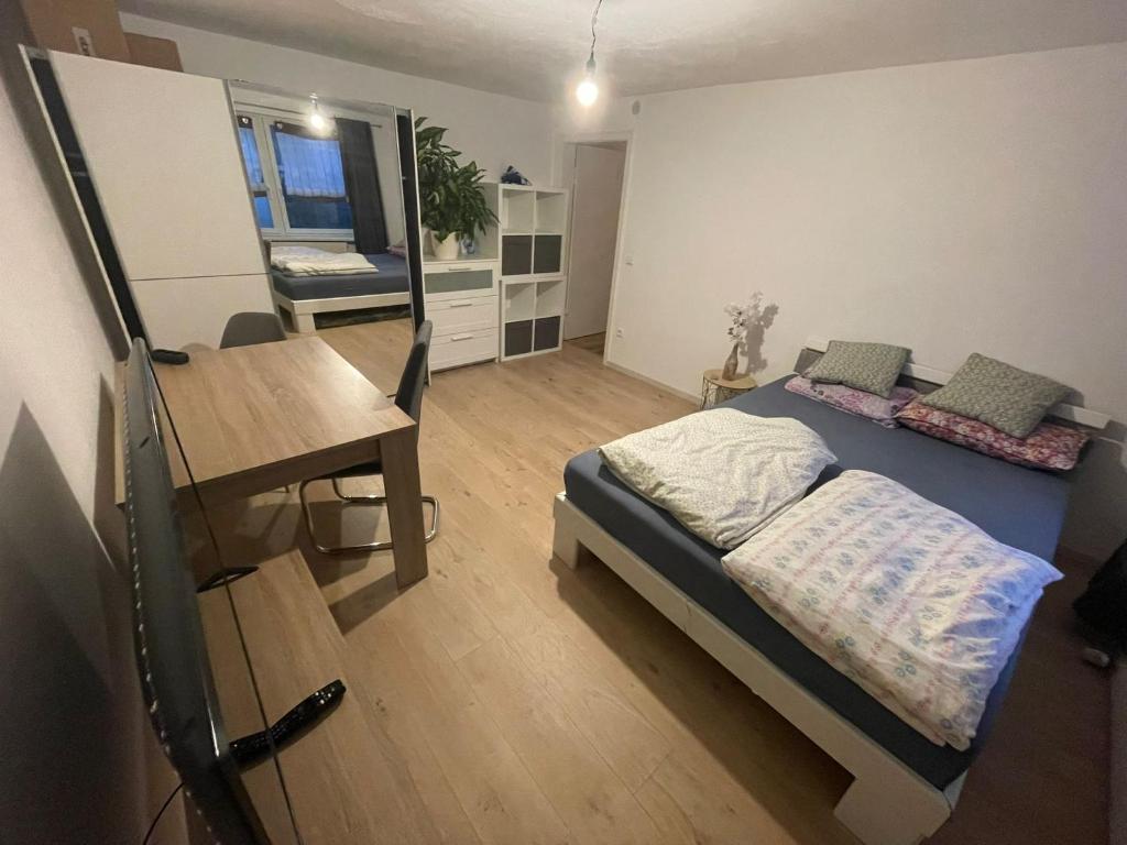 a bedroom with a bed and a table and a desk at Appartement in Hof Bayern in Hof