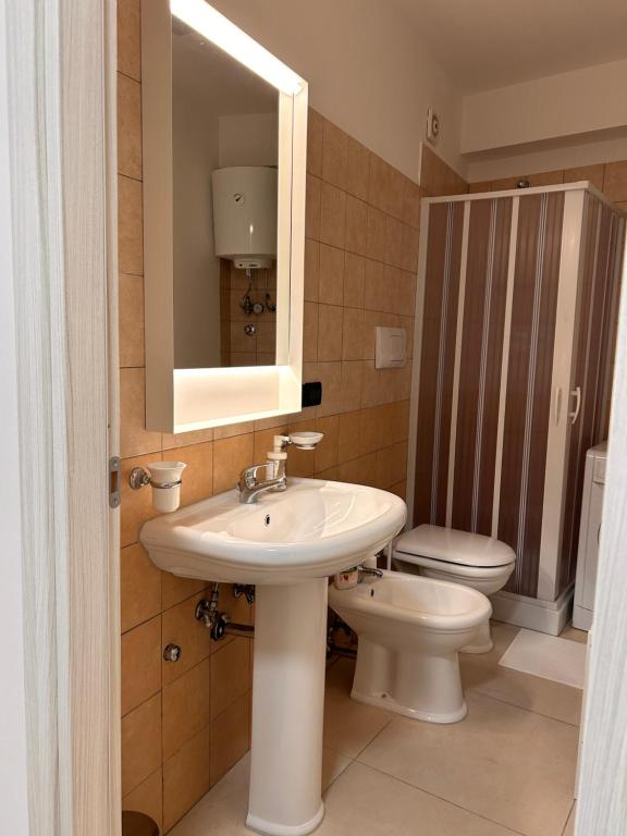 a bathroom with a sink and a toilet at Casa Morgana camera Irene in Scilla