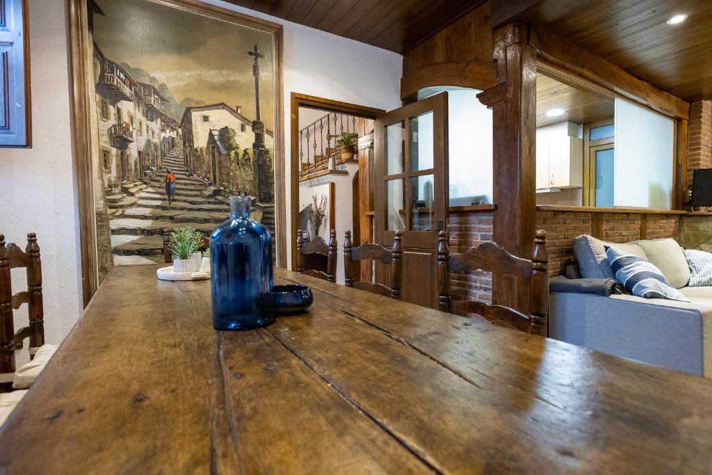 a blue bottle sitting on a wooden table in a room at Casa LART RUPIT in Rupit