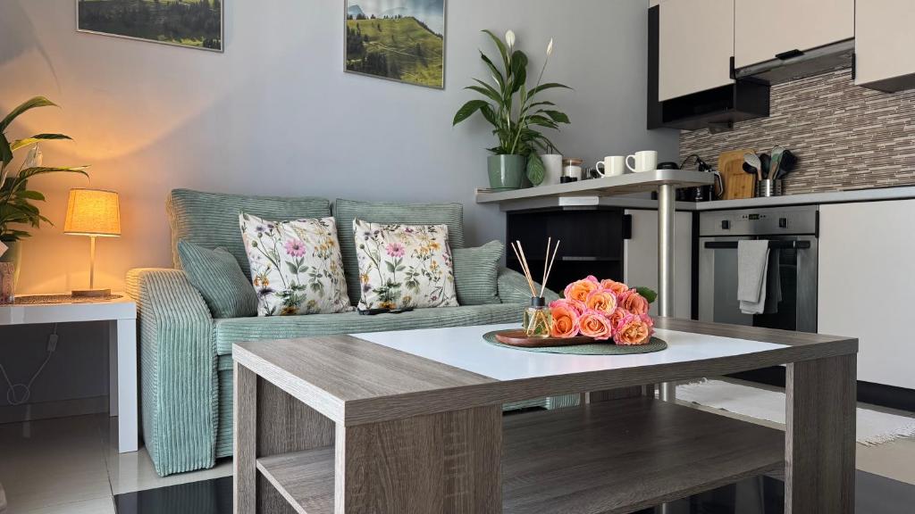 a living room with a table and a couch at Apartament Słoneczny 27 in Bielsko-Biala