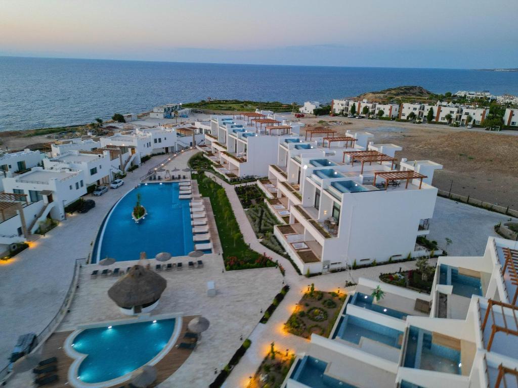 an aerial view of the hotel and the ocean at Mykonos Holiday Homes in Kyrenia