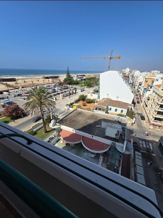 a view of a city from a balcony at Monte G Sea View in Monte Gordo