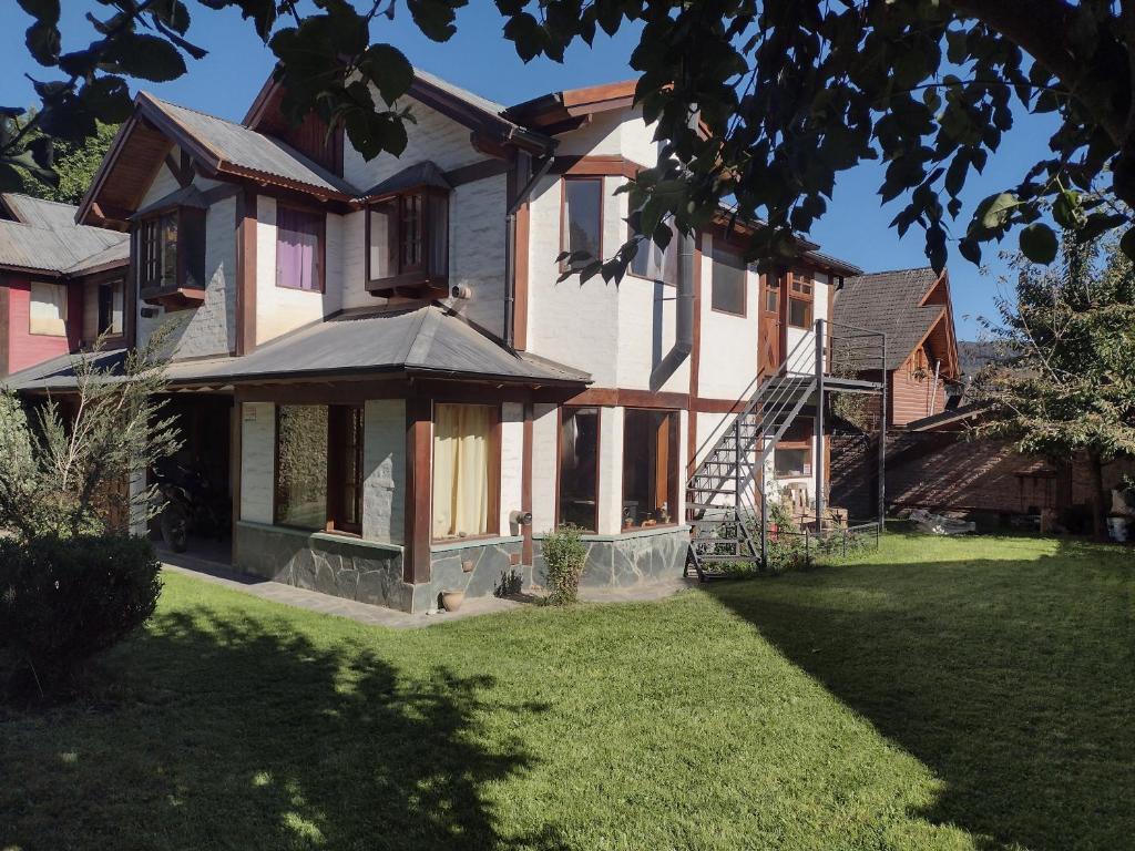 a large house with a lawn in front of it at Casa Sueño in San Martín de los Andes