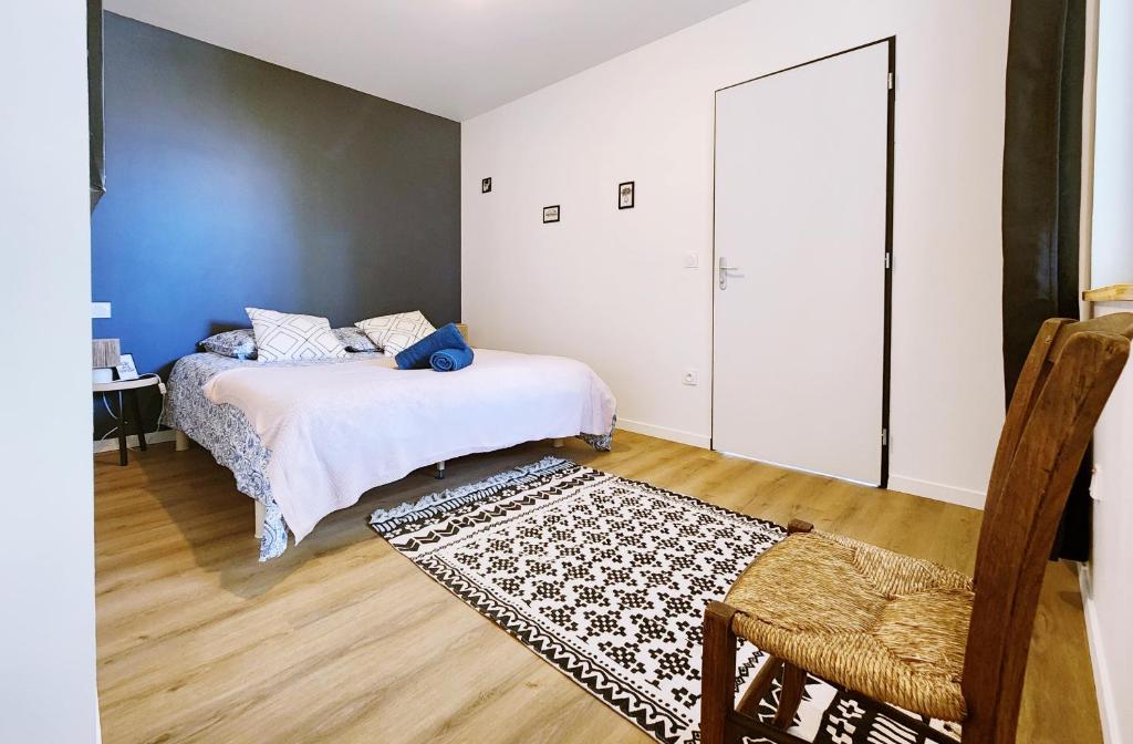 a bedroom with two beds and a rug at Polka - RDC - Centre ville - Terrasse in Auch