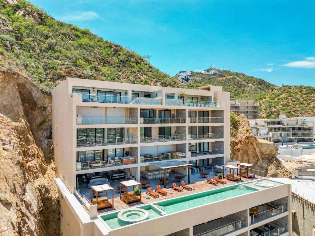 an image of a building with a swimming pool at Luxury Pedregal Condo - Views, Pool & Concierge in Cabo San Lucas
