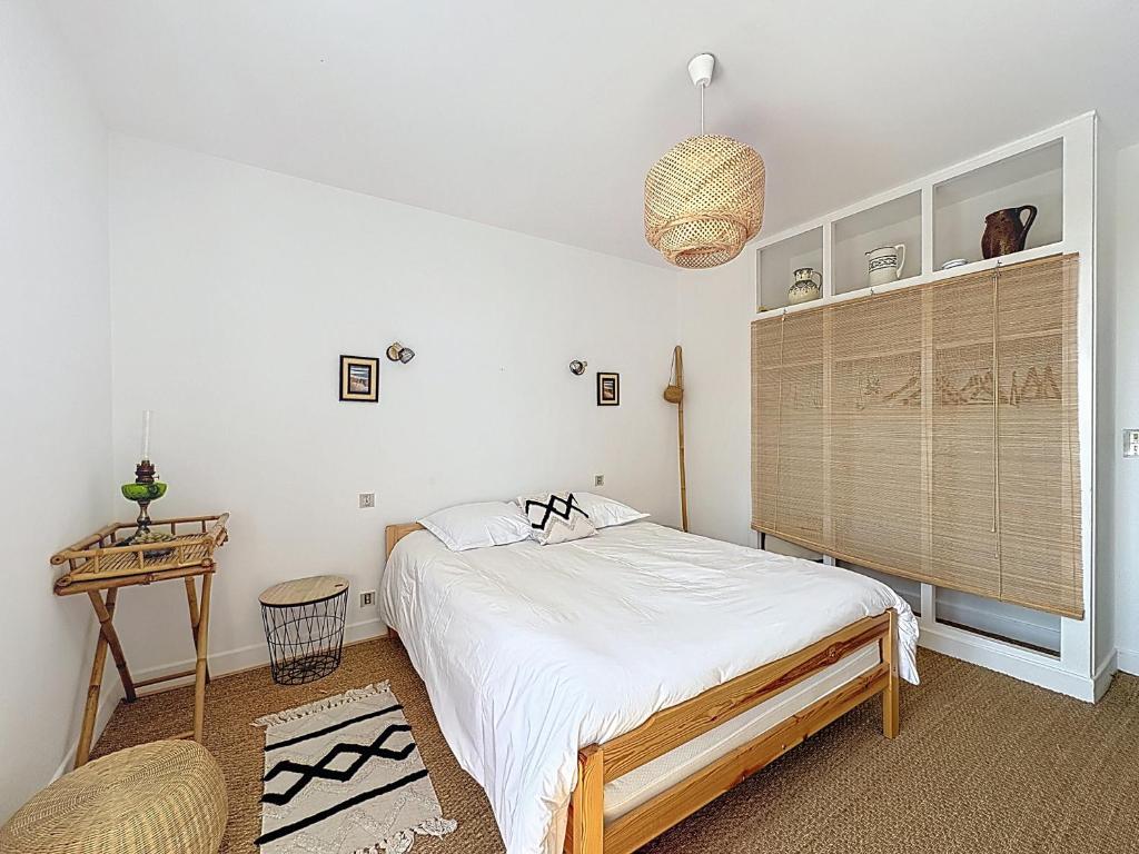 a bedroom with a bed and a table in it at Au 19 in Tanlay