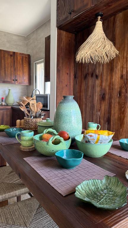 a wooden table with bowls of food on it at Cozy 2BRs chalet in Einbay Boho designed in Ain Sokhna