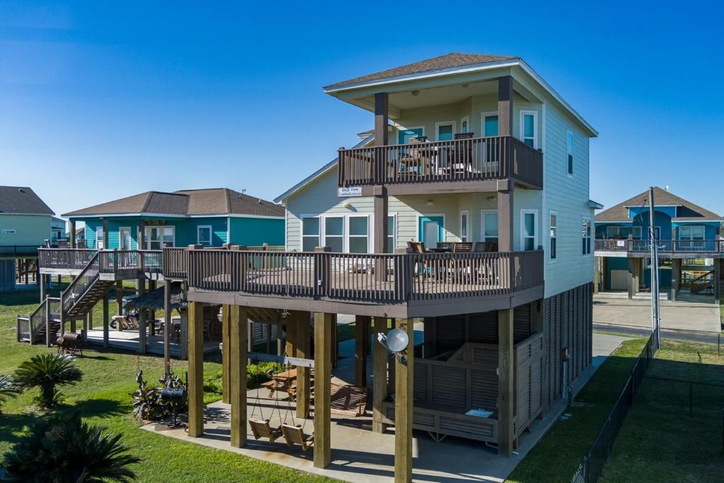 a house with balconies on the side of it at Deja View Home in Stingaree