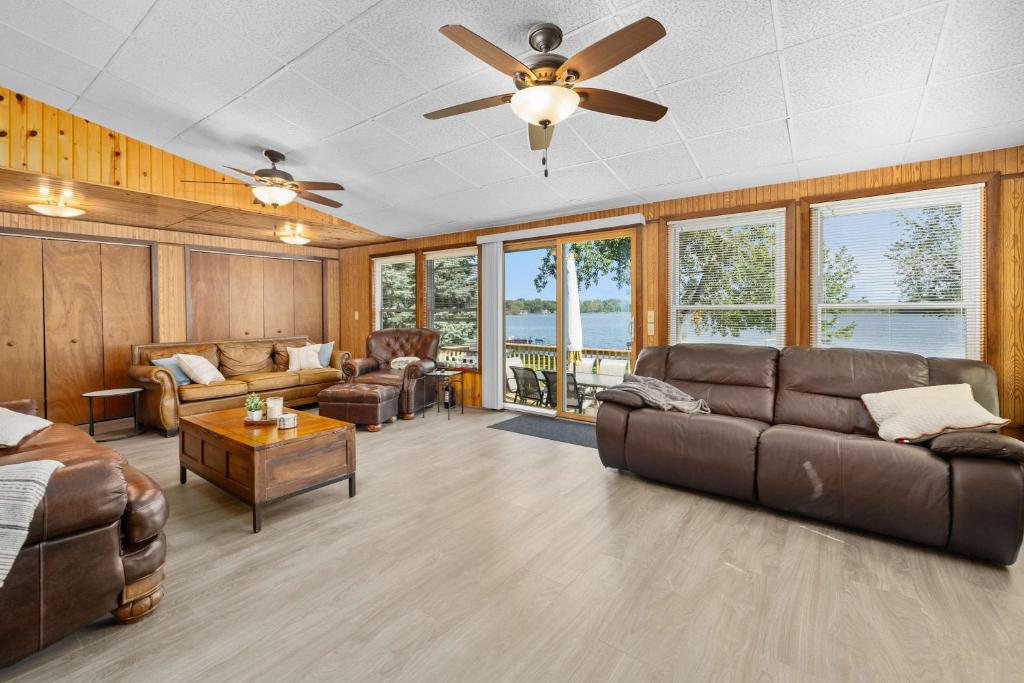 a living room with a couch and a ceiling fan at Family-Friendly Lakehouse with Firepit and Dock in Warsaw
