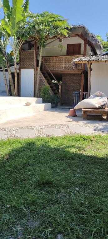 a house with a ramp in front of a building at J home stay in Maluk