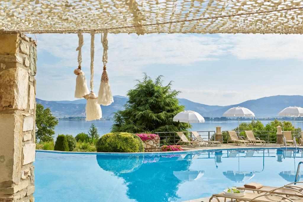 a swimming pool with a view of the water at Limneon Resort & Spa in Kastoria