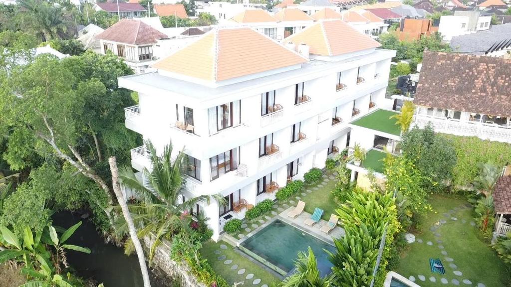 an aerial view of a white house with a swimming pool at PUSPA guest house in Canggu
