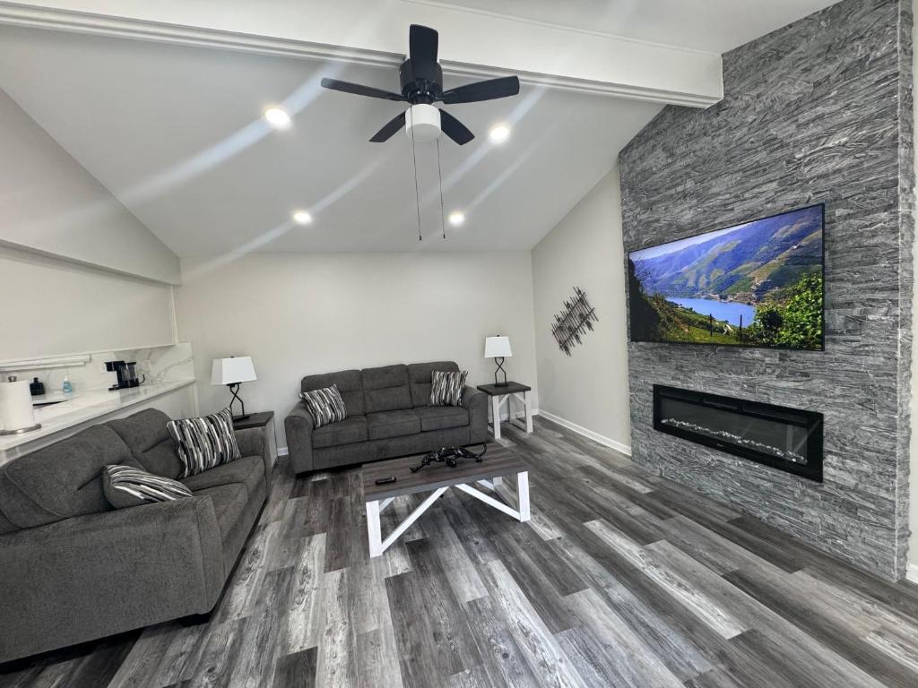 a living room with a couch and a fireplace at Modern Family Home -3BR -High Speed Wi-Fi Comfort in Sterling Heights