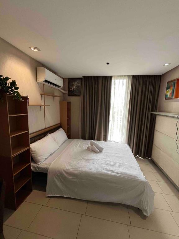 a hotel room with two beds and a window at Antel Spa Residences 10EE in Manila