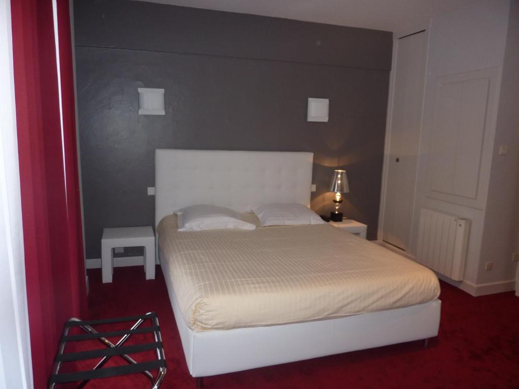 Postel nebo postele na pokoji v ubytování Hôtel Le Square