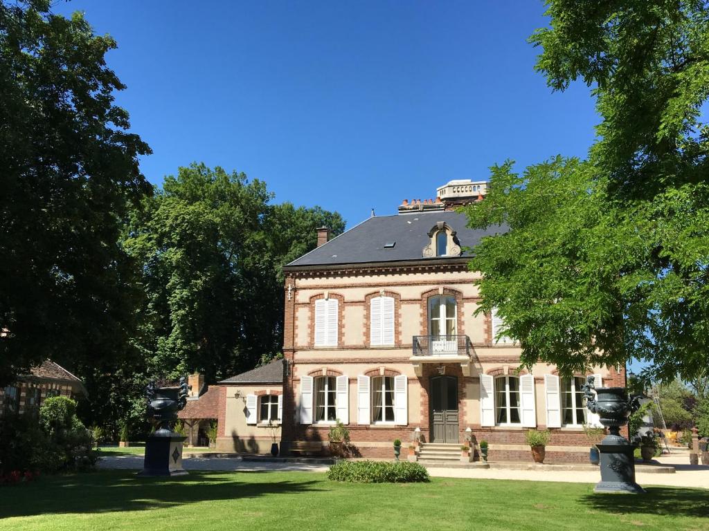 a large brick house with a black roof at Château de Montabert in Montaulin