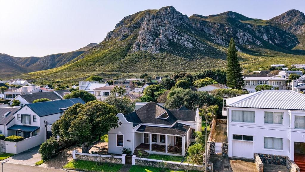 a city with a mountain in the background at Mountainside Family Beach House - Pet Friendly in Hermanus