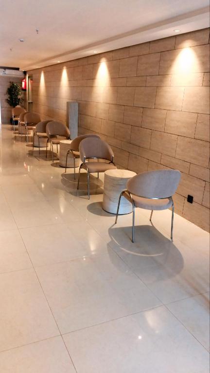 a row of chairs and tables in a lobby at رير بلو دايموند 2 للشقق المخدومة تصنيف اقتصادي in Taif