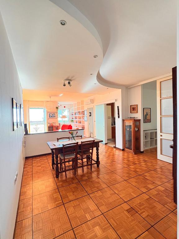 a kitchen and dining room with a wooden table at Casa Bonomea in Trieste