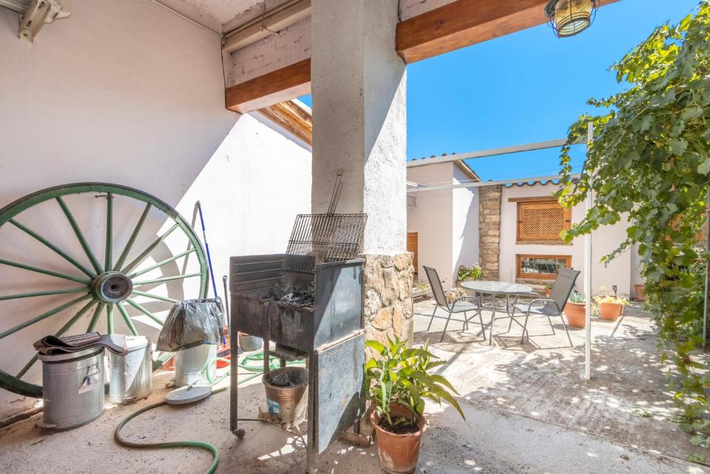 a patio with aoked wheel and a table and chairs at Casa Ramona in Conques
