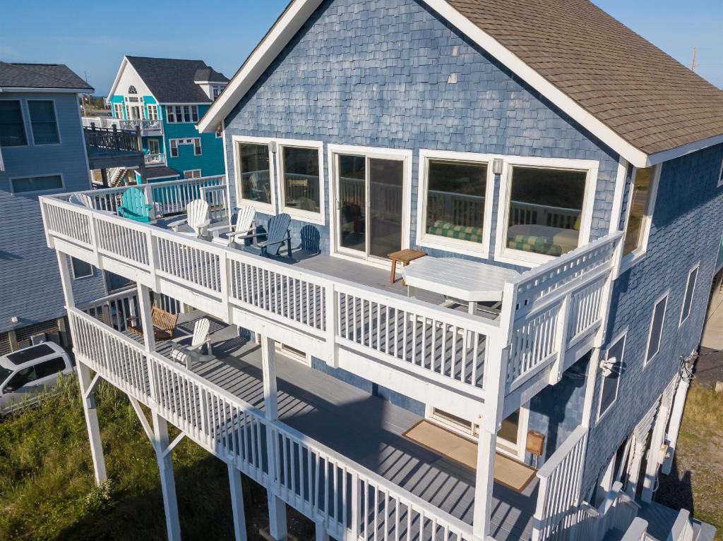 an aerial view of a blue house with a white deck at Genesis On The Water, Views! Views! Views! in Rodanthe