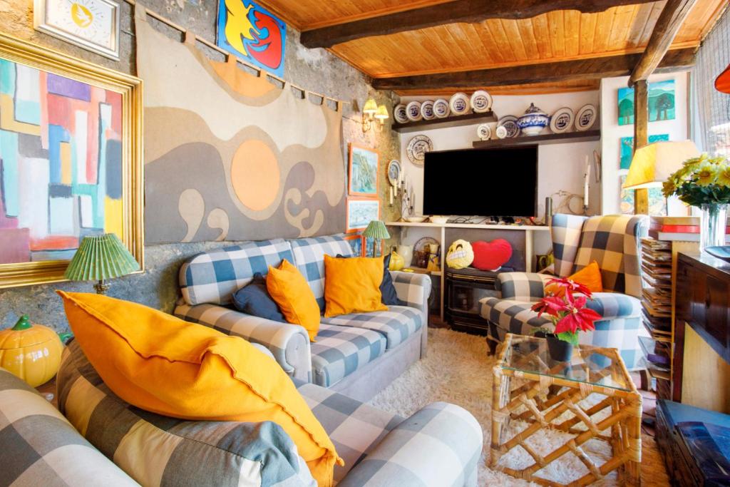 un salon avec des canapés et une télévision à écran plat dans l'établissement Casa do Campo Dornes Um, à Paio Mendes