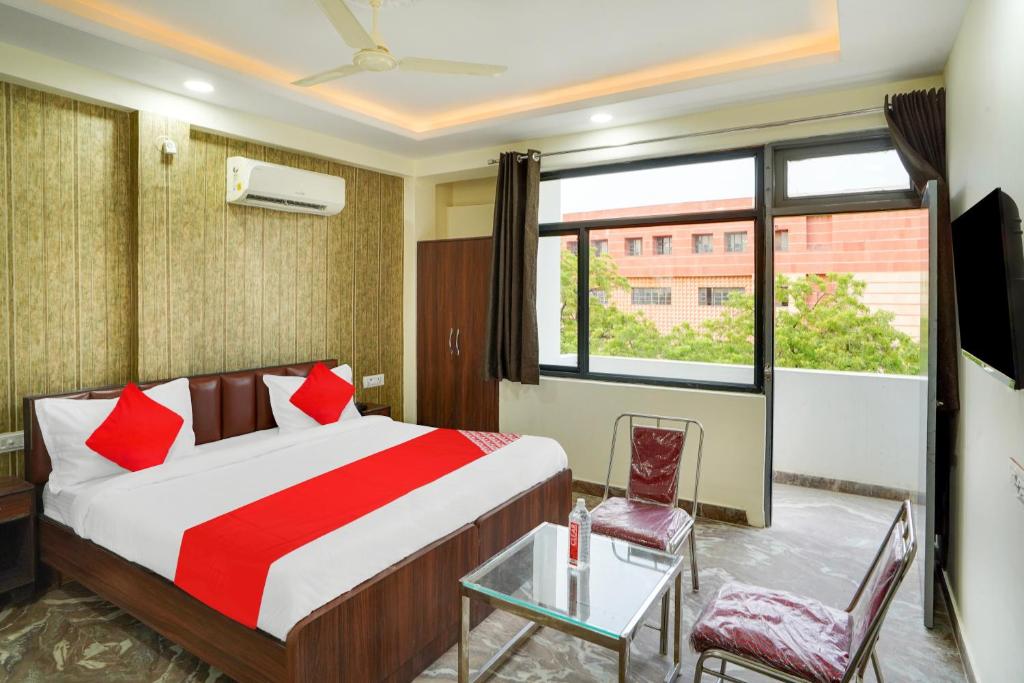 una habitación de hotel con una cama y una ventana en Hotel O Uday, en Jaipur