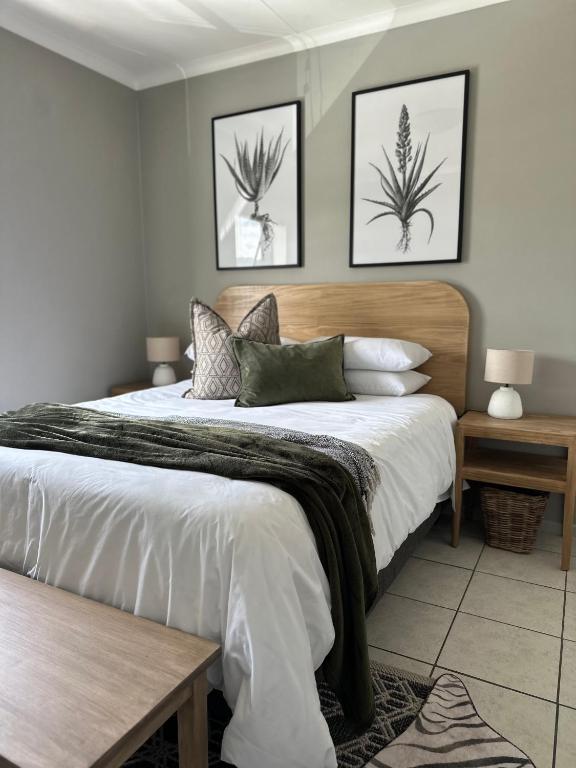 a bedroom with a large bed with a wooden headboard at Lang Apartment in Great Brak River