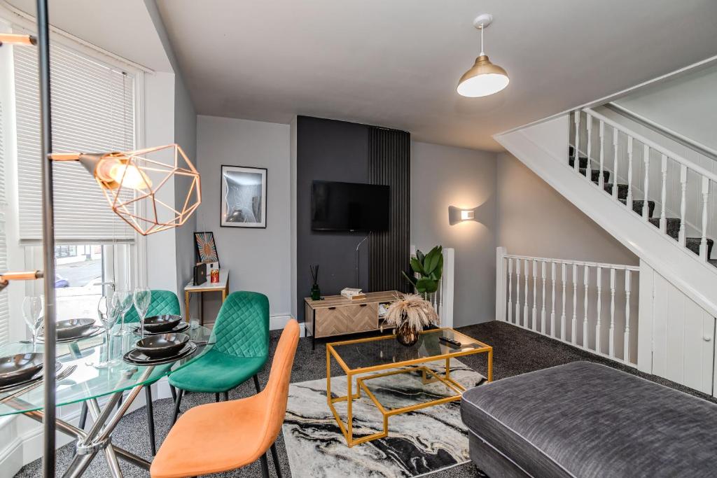 a living room with a glass table and chairs at Eastbourne 2 Bedroom Apartment Next to Shopping Centre and Beach in Eastbourne