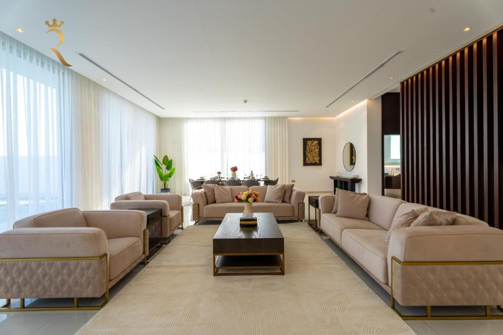 a large living room with couches and a table at Modern Villa Aquira with 5BR Private Pool in Yas Island in Abu Dhabi