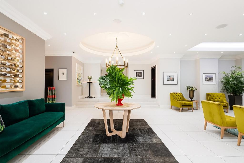 a living room with a green couch and a table at Tranquil Haven in Cape Town