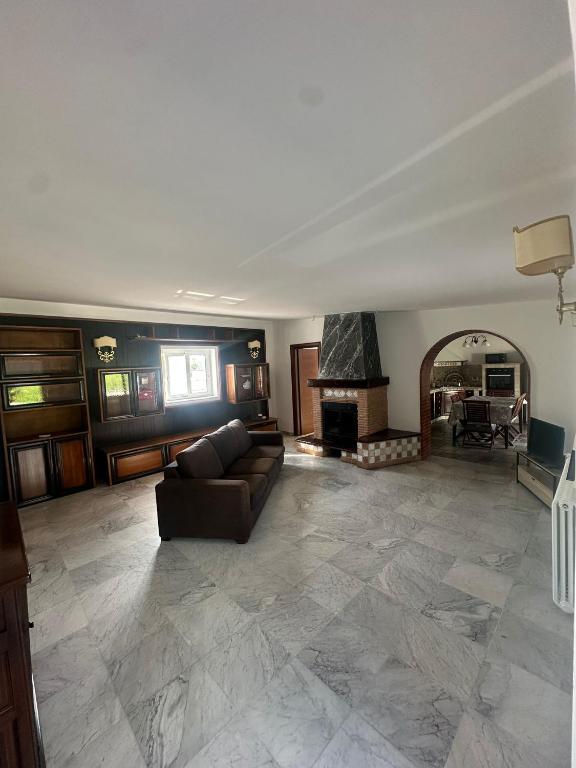 a living room with a couch and a fireplace at Villa Lelli 2 in Rome