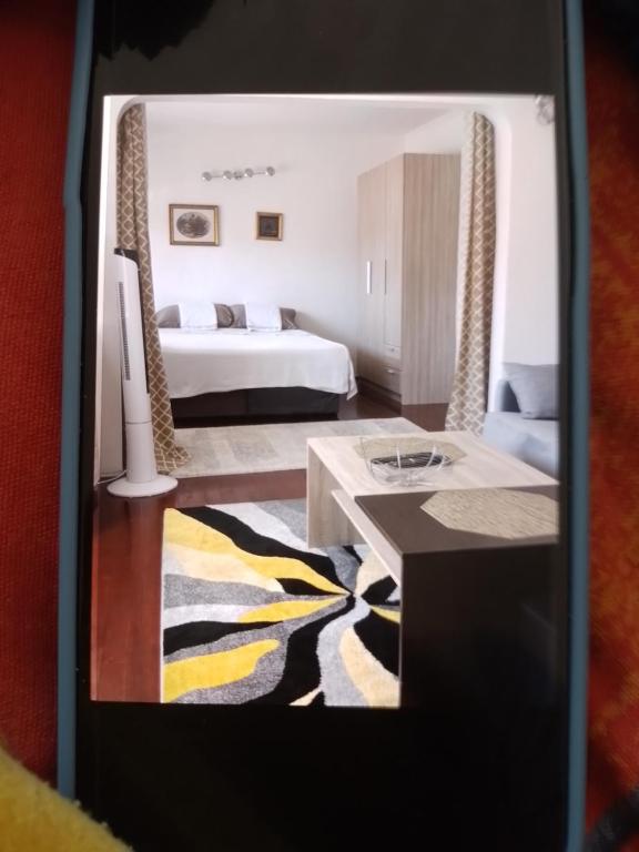 a living room with a bed and a table at Edinhome in Sarajevo