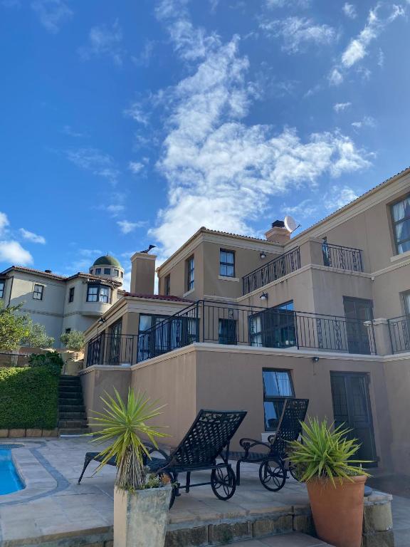 a building with two benches in front of it at 22 on Shiraz 2 in Bellville