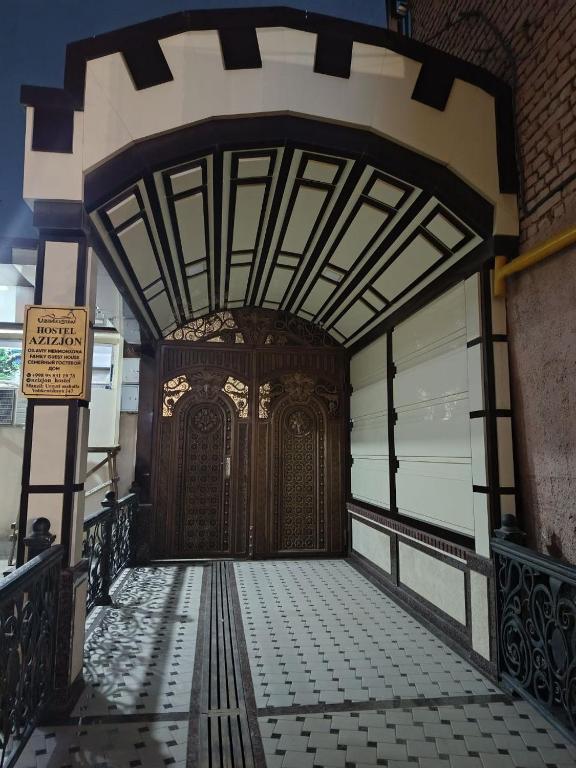 an entrance to a building with a large wooden door at Hostel Azizjon in Samarkand