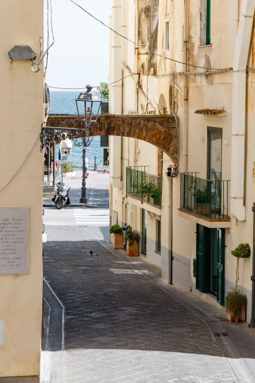 an alley between buildings with the ocean in the background at Francy holiday House NEW at 20 meters from sea in Minori