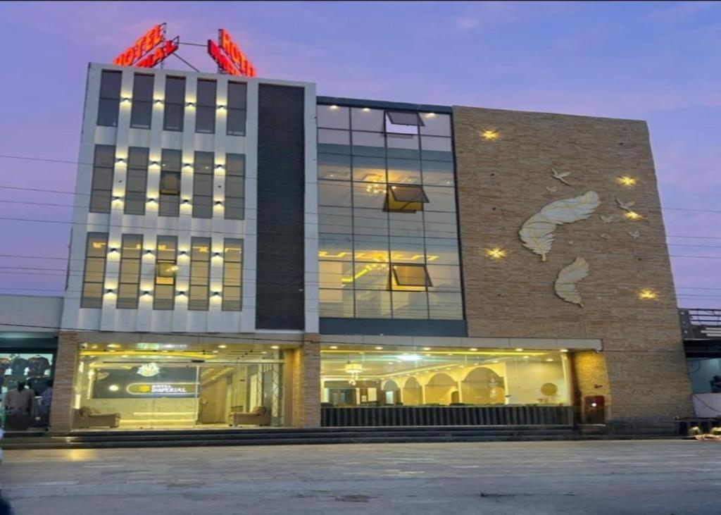 a building with a store front with lights in it at Hotel Imperial in Dabok