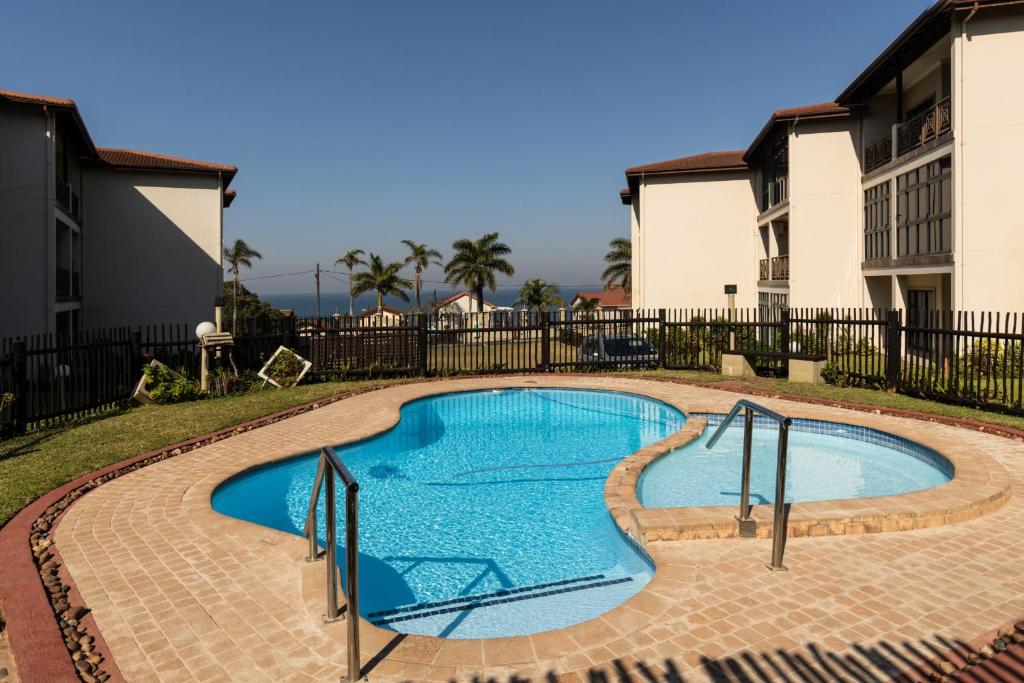 a swimming pool in the middle of a yard at Topanga Beach Apartment in Margate