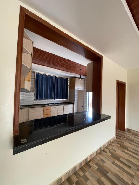 a kitchen with a sink and a large mirror at House For Rent In Rusororo fully furnished in Kigali