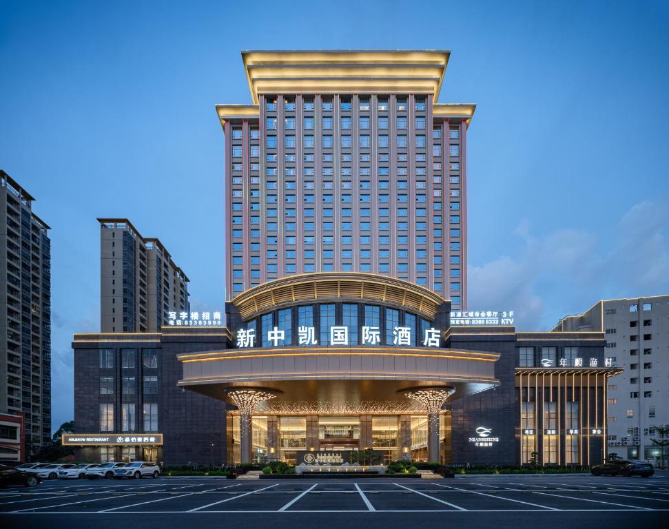 a large building with a parking lot in front of it at SINOKAI International Hotel in Dongguan